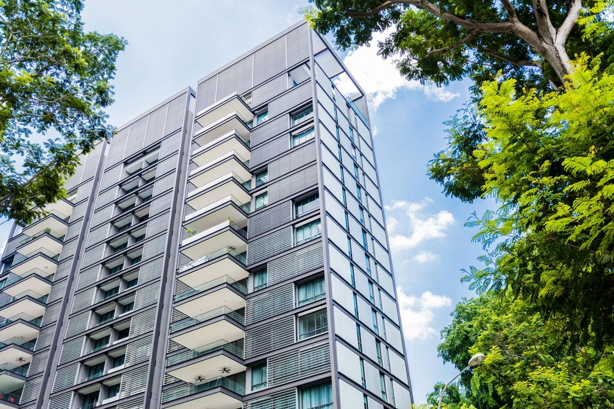 A tall building with many windows and trees